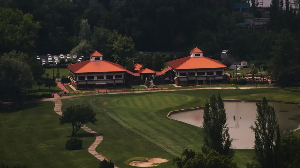 A golf clubhouse overlooking the course and a water hazard
